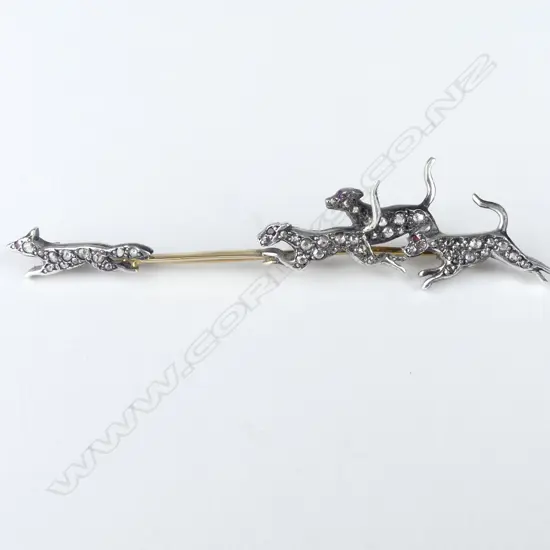 A decorative gold silver and diamond set fox hunting brooch