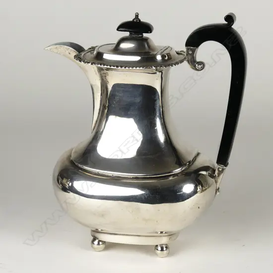 A silver hot water pot