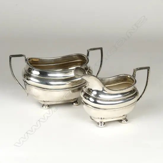 A Georgian Revival silver milk jug and sugar basin