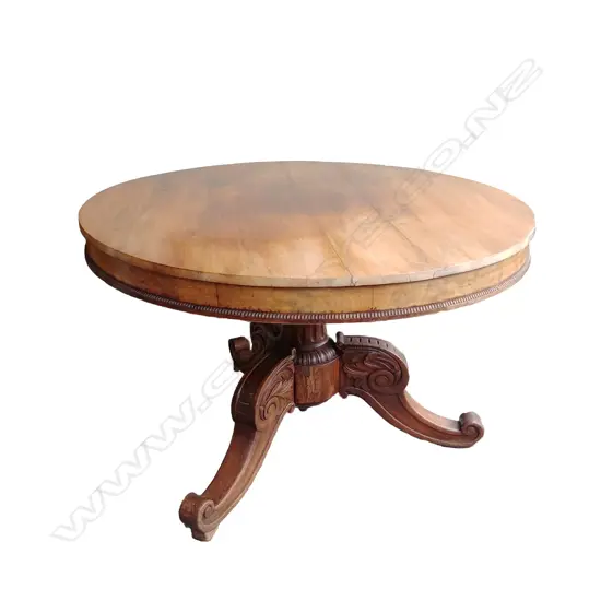 A 19thC French walnut circular drum top dining table