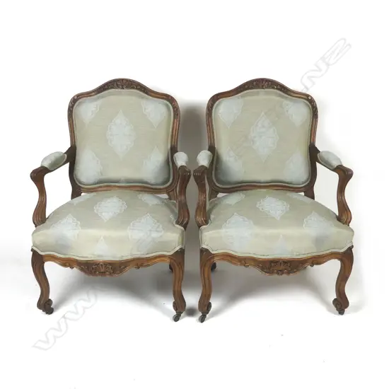 A pair of open elbow armchairs