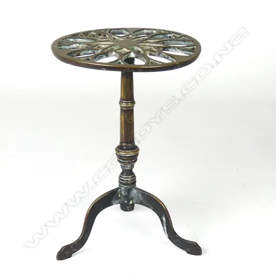 A Victorian brass fireside trivet