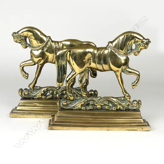 A pair of Victorian brass doorstops