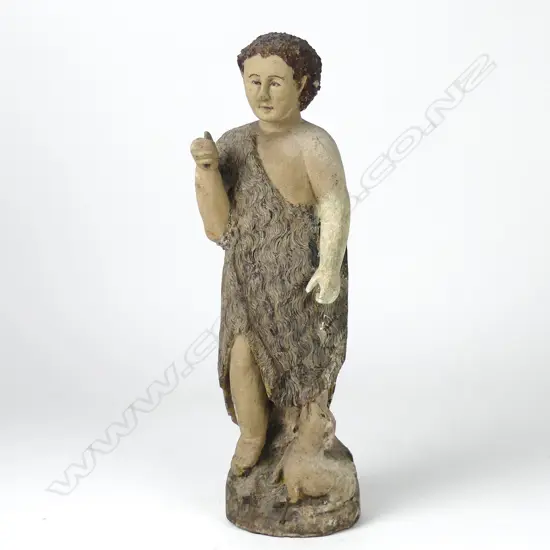 A naive carved wooden statue of St John the Baptist