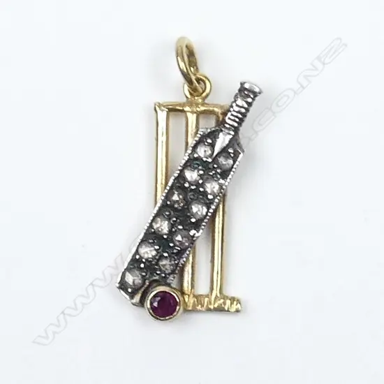 An Edwardian gold and silver cricket pendant