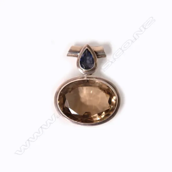 A lady's modern silver large topaz and tanzanite pendant