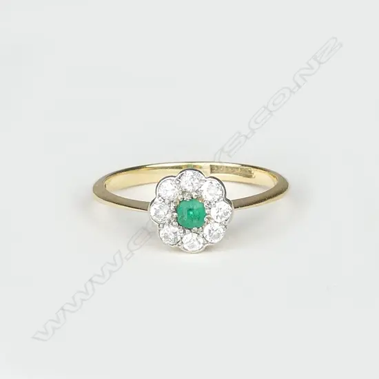 An 18ct gold emerald and diamond cluster ring