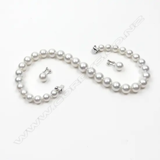 An 18ct. white gold and diamond clasped silver white freshwater pearl necklace