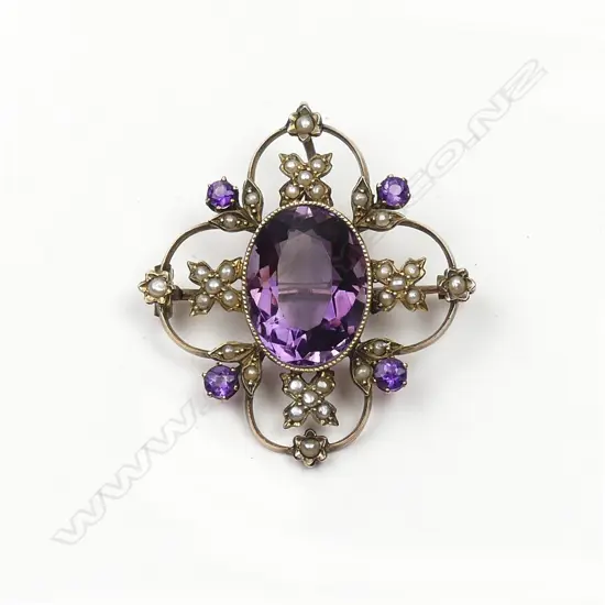 An early 20thC 9ct. gold amethyst and seed pearl decorative brooch