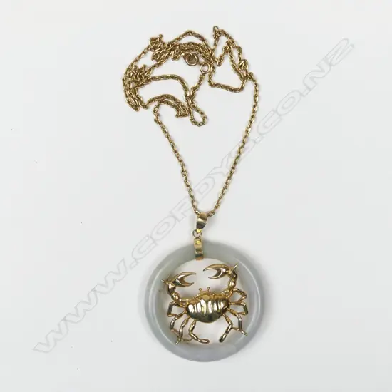 A 14ct gold and jade pendant
