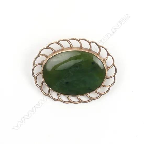 A 9ct. rose gold framed greenstone brooch