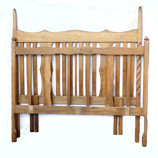 A pair of Chapman-Taylor carved rimu double bed ends