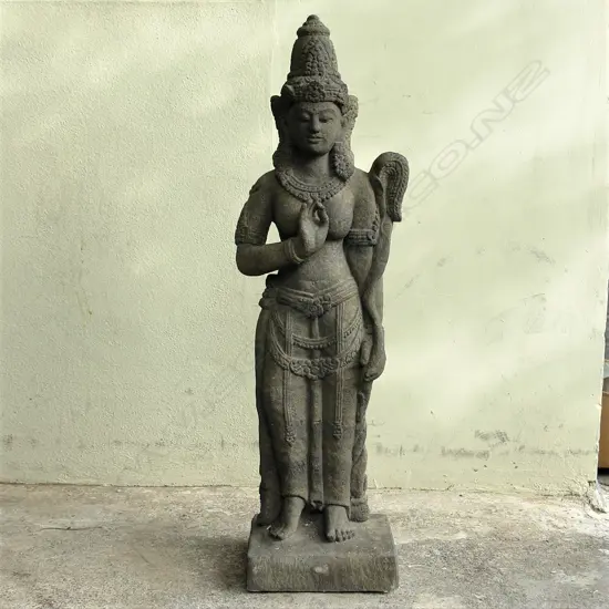 A solid composite stone figure of a standing mythical being Yakshi