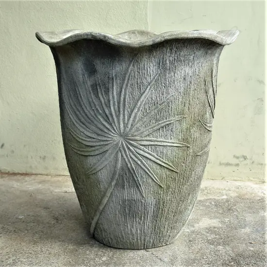 A large sculpted concrete urn form garden fountain water feature