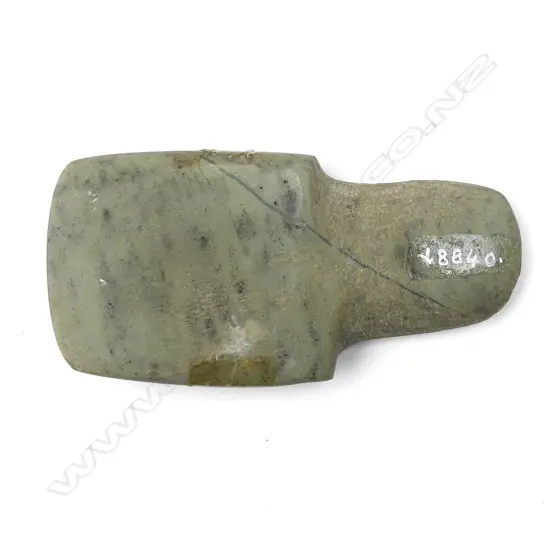A small grey-green stone adze blade