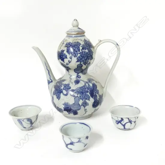A Chinese blue and white porcelain wine ewer and three small cups
