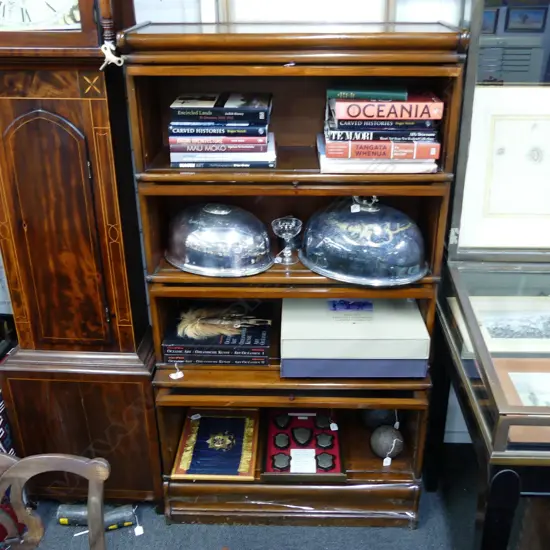 An American mahogany sectional bookcase in the manner of Globe Wernicke