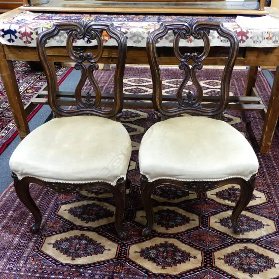 A pair of Victorian walnut dining chairs