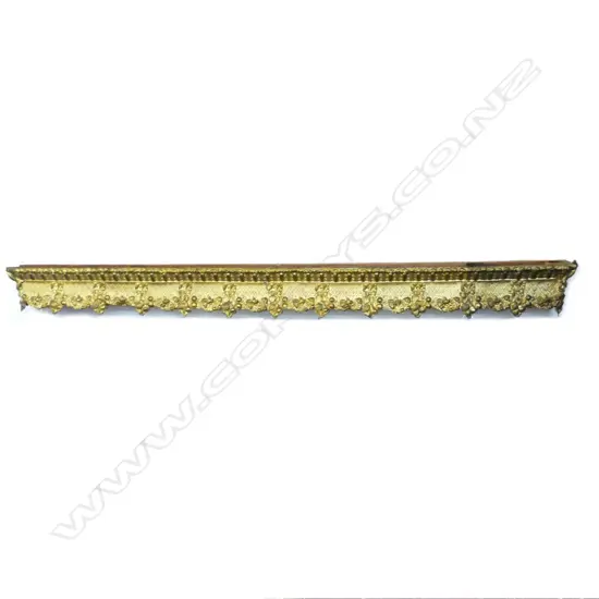 A long decorative antique gilt metal curtain pelmet with wooden back