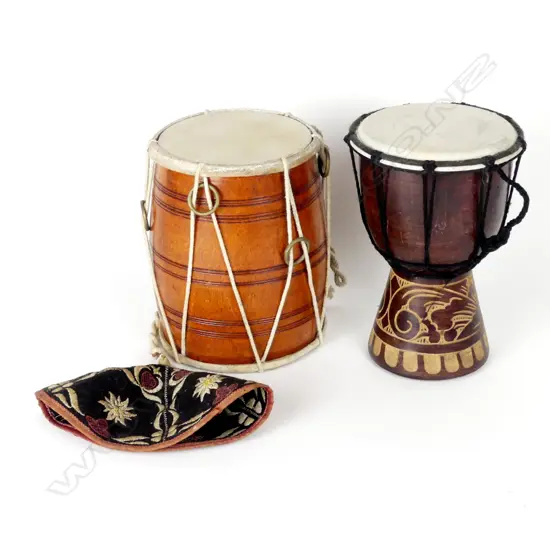Two small bongo drums and an embroidered felt cap