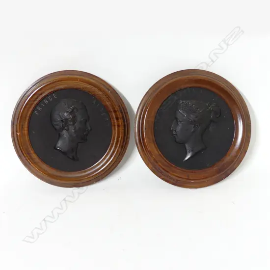 A pair of bois durci framed plaques