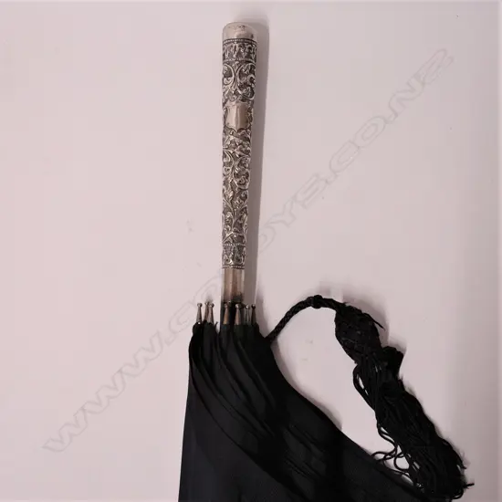 An early 20thC silver handled lady’s parasol