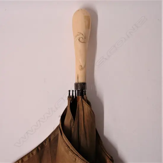 An early 20thC carved marine ivory handled lady’s parasol