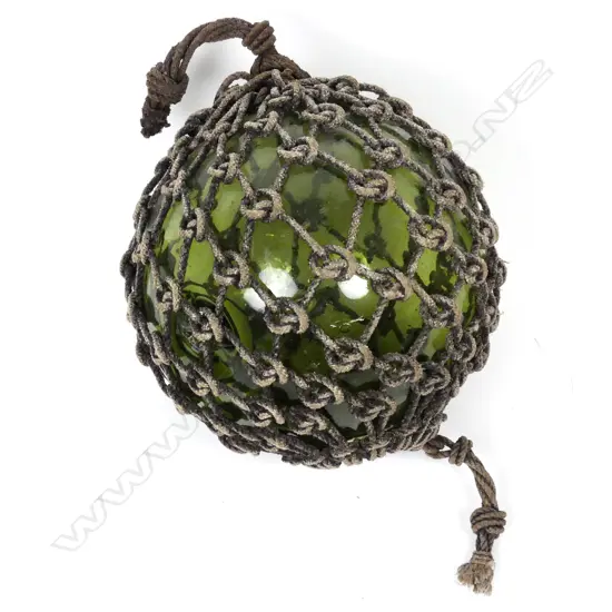 A large green glass fishing buoy