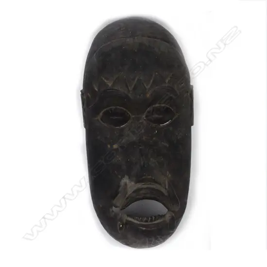 A vintage tribal carved wooden mask