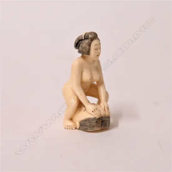 A vintage carved ivory erotic netsuke