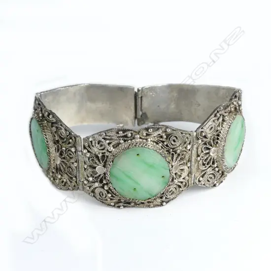 A mid-20thC Chinese filigree silver and jadeite panelled bracelet