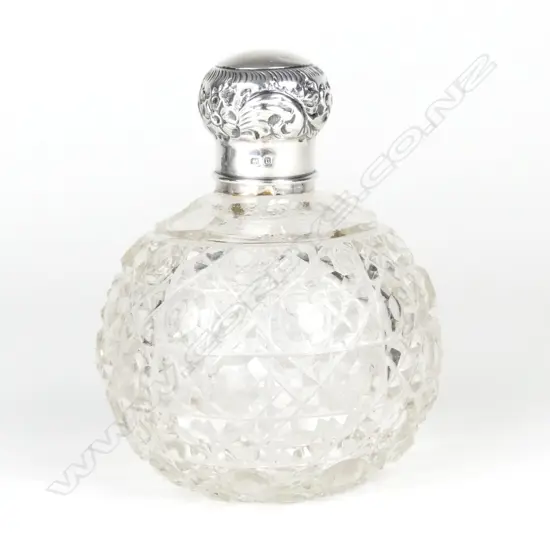 A silver topped cut crystal scent bottle