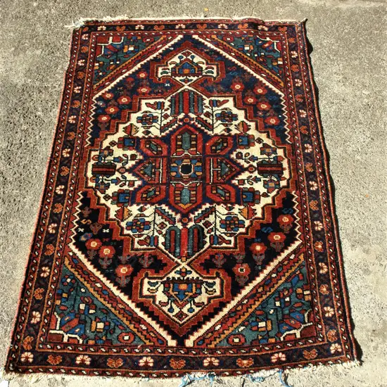 A Persian semi-antique wool on cotton rug