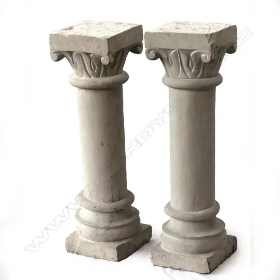 A pair of small concrete Corinthian columns
