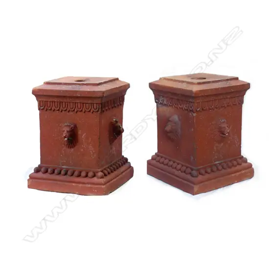 A pair of terracotta garden plinths