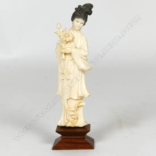 A Chinese carved ivory figure of a woman