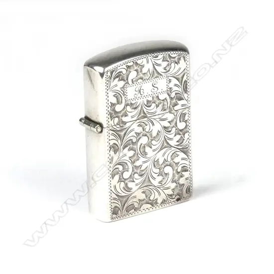 A silver cased Zippo lighter