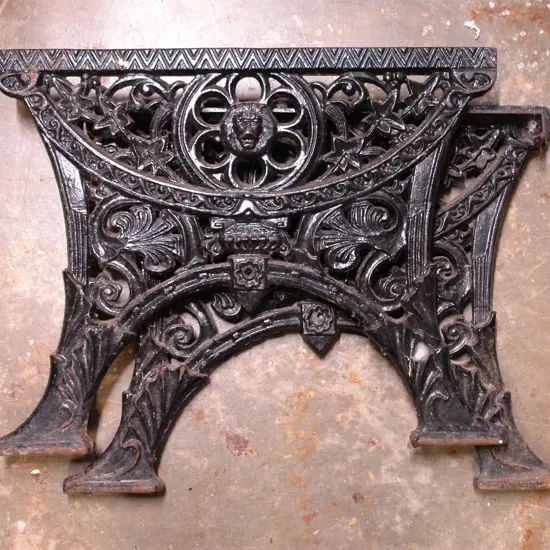 A pair of vintage cast iron garden bench ends