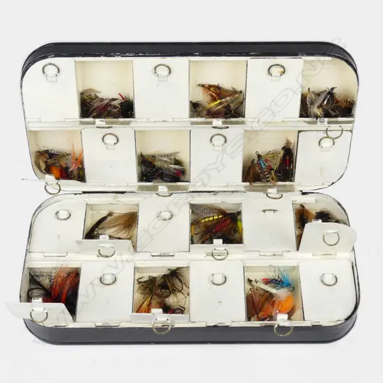 A vintage black tin fly box