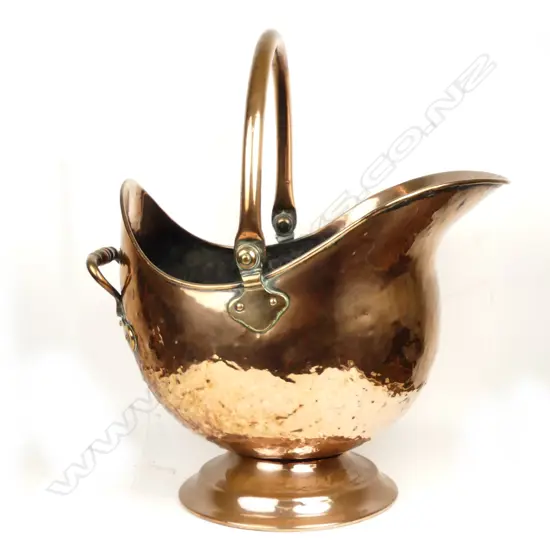 A Victorian copper helmet coal scuttle
