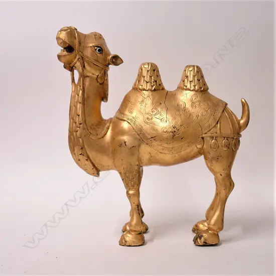 A Chinese carved and gilded temple camel