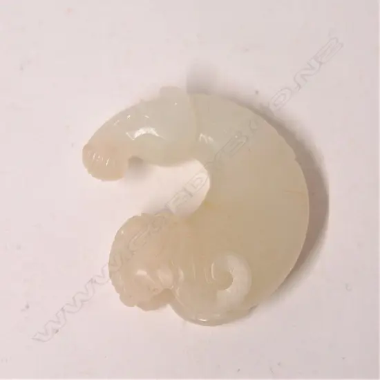 A Chinese white jade horseshoe pendant