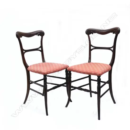 A pair of Victorian balloon back dining chairs