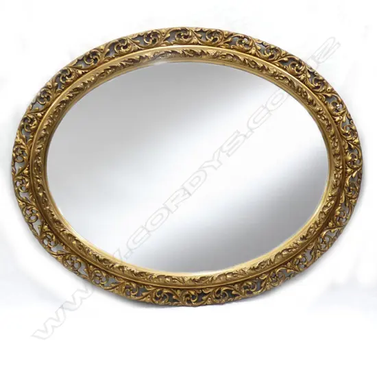 A 20thC large oval gilt plaster carved framed mirror