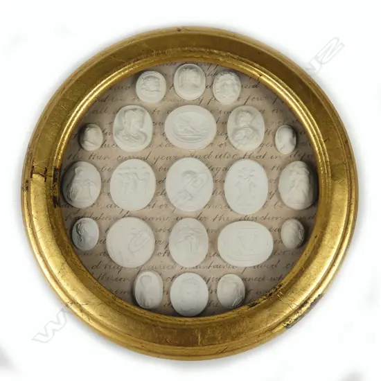 A circular gilt framed collection of small plaster cameo and intaglio plaques