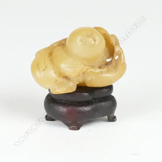 A small Chinese greenish-brown jade fingering piece