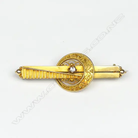 A 15ct. gilded yellow gold and diamond bar brooch