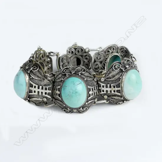 A mid-20thC Chinese filigree silver and turquoise cabochon bracelet