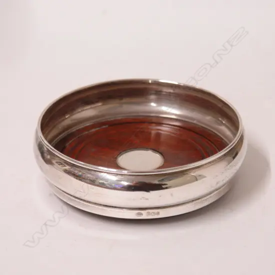 A modern silver and turned wood bottle coaster