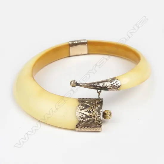 A colonial 9ct gold tusk bangle
